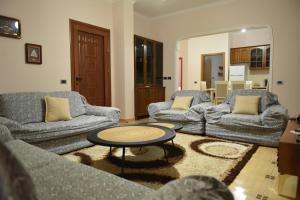 a living room with two couches and a coffee table at Residence Rudaj in Vlorë