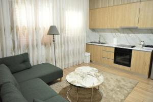 a living room with a couch and a table at Residence Rudaj in Vlorë
