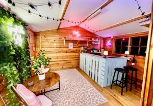 a room with a bar and a table and chairs at The Natures Nook With HotTub in Talog +15 photos