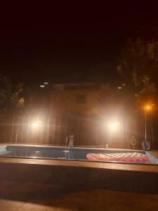 a swimming pool at night with lights on it at Pousada Coral in Osório +1 photo