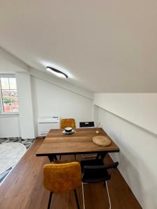 a dining room with a wooden table and chairs at COSMOS Panorama Apartments in Prilep