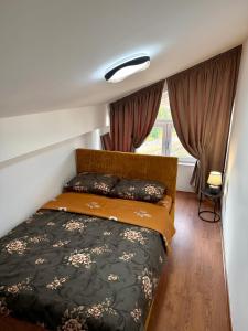 a bedroom with a bed in a room at COSMOS Panorama Apartments in Prilep