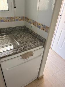 a small kitchen with a counter top and a sink at Mar de Cristal in Mar de Cristal +16 photos