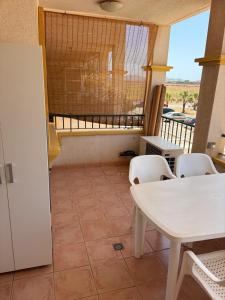 a room with a table and chairs and a balcony at Mar de Cristal in Mar de Cristal