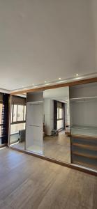 an empty room with a large mirror in the middle of a room at Cosy Duplex, Pool & Free Parking Steps to Beach in El Harhoura