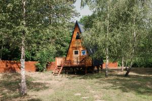 a cabin in the middle of a forest with trees at Tesla`s Valley in Smiljan