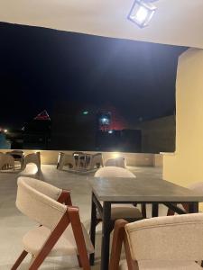 a room with chairs and a wooden table and chairs at Saqqara Pyramids view Hotel in Cairo