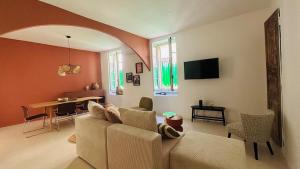 a living room with a couch and a table at Appartement arche centre historique in Narbonne +9 photos