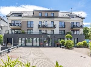 an apartment building with a courtyard in front of it at Berliner Hof Bed&Bike in Saint-Vith