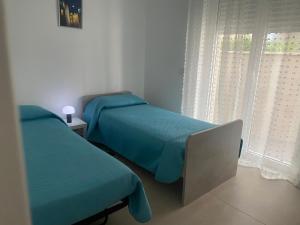 a bedroom with two beds and a window at B&b al borgo in Modugno