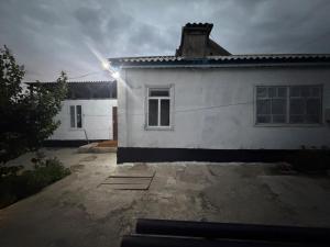 a white house with a light on top of it at NurNomad 2 in Balykchy