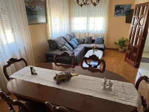 a living room with a table and a couch at Casa Ezaro in Dumbría