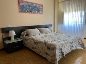 a bedroom with a large bed and a window at Casa Ezaro in Dumbría
