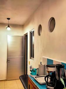 a kitchen with a counter top with a refrigerator at Departamento Refugio Verde in Palenque
