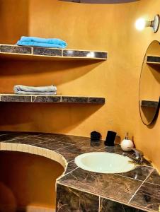 a bathroom with a sink and a mirror at Departamento Refugio Verde in Palenque +8 photos
