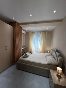 a bedroom with a large bed and a window at Coastal dreams Golem in Golem