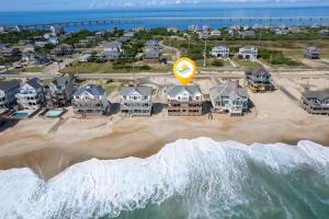 an aerial view of a beach with houses at 8045 - Mirlo Hi in Rodanthe +90 photos