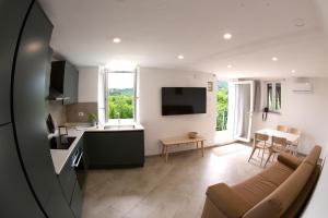 a kitchen and living room with a couch and a table at A Casa di Gaia 2 in San Benedetto