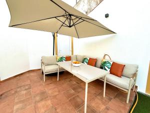 a table and two chairs and an umbrella at Casa Vila de Frades in Vila de Frades