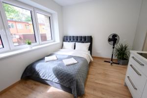 a bedroom with a bed and a window at NOVA Apartment - 1 in Klaipėda