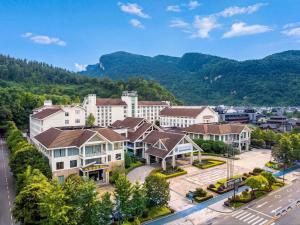 an aerial view of a town with mountains in the background at Pullman Zhangjiajie Hotel in Zhangjiajie