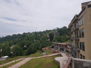 arial view of a building with a hill in the background at Saadis cottage in Bhurban