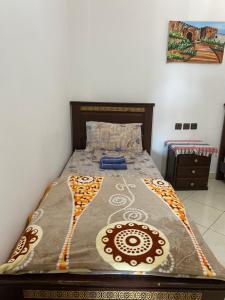 a bed in a bedroom with a bedspread on it at TANJALUCIA HOSTeL in Tangier