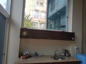 a kitchen sink with a mirror above a window at Saadis cottage in Bhurban +21 photos