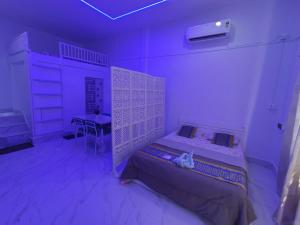 a bedroom with a bed in a purple room at Lakhimpur Central Homestay - Unmarried couples not allowed in North Lakhimpur