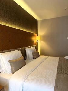 ein großes weißes Bett in einem Hotelzimmer in der Unterkunft KBF Hotel in Alger