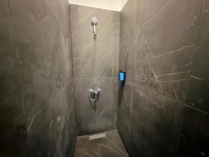 a bathroom with a shower with a stone wall at Hostel Vento in Bar +8 photos
