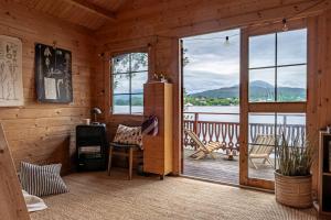 a room with a door leading to a balcony with a view at Fjord View Off-Grid Cabin in Ålesund +27 photos