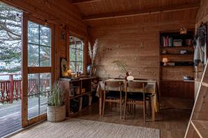 a dining room with a table and chairs in a cabin at Fjord View Off-Grid Cabin in Ålesund