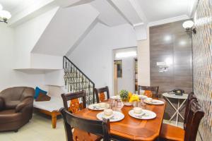 a dining room with a wooden table and chairs at Diamond Villa - The Dream Stays ll Pvt Pool ll Wi-Fi ll 2AC Rooms in Lonavala