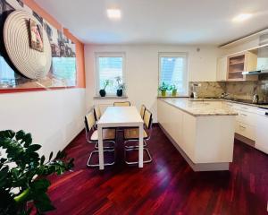 a kitchen with a table and chairs in it at Lanas place in Ljubljana