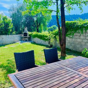a wooden table and two chairs in a yard at Lanas place in Ljubljana