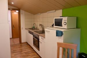 a kitchen with a microwave on top of a refrigerator at Haus Helene in Sankt Gallenkirch