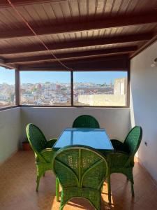 a table and chairs with a view of a city at TANJALUCIA HOSTeL in Tangier