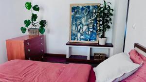 a bedroom with a bed and a painting on the wall at Lanas place in Ljubljana