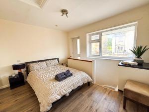 a bedroom with a bed with a backpack on it at The Lodge Mews in Shaw Mills