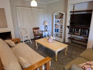 a living room with a couch and a table at Casa La Bendición in Mar del Plata