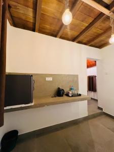 a room with a counter with a tv on a wall at Coffee Cabanas in Matale