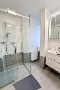 a bathroom with a glass shower and a sink at Paky Appartements 00209 in Vienna