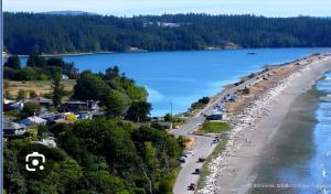 an aerial view of a beach and water at Spacious Private Suite Minutes Away from Ocean,Trails and Stores in Langford +4 photos