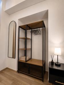 a shelf in a room with a mirror at Domus Regina Sforza in Capurso