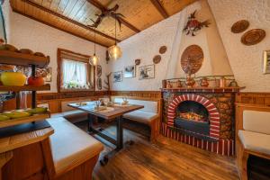 a living room with a fireplace and a table at Hotel Garnì La Montanara in Madonna di Campiglio