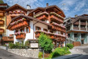 a building with flower boxes on the balconies at Hotel Garnì La Montanara in Madonna di Campiglio