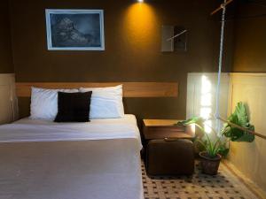 a hotel room with a bed and a suitcase at Galerie Guanajuato Centro in Guanajuato