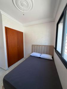 a bedroom with a large bed in a room at Mini Villa Azur - Bord de Mer in Driouch +4 photos