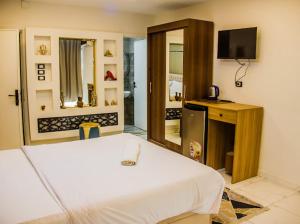 a bedroom with a bed and a tv in it at Miracle Pyramids View Hotel in Giza +75 photos